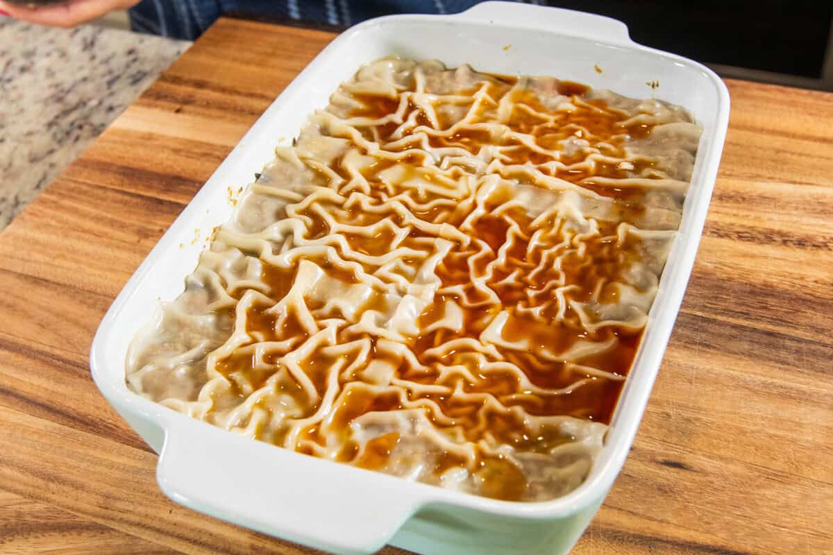 adding sawsawan to dumpling lasagna