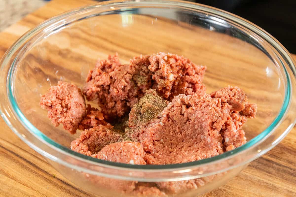 seasoning the plant based ground with salt and pepper