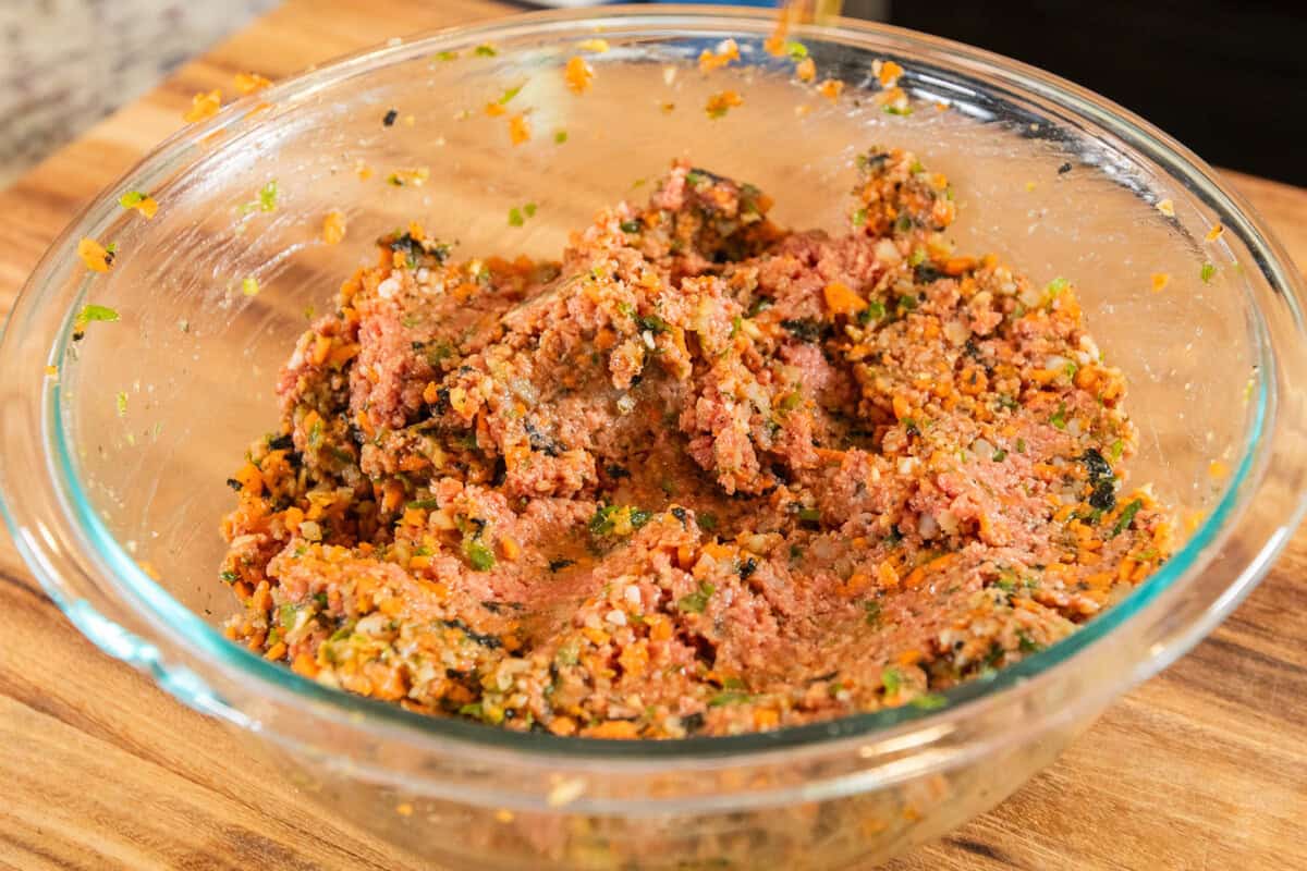 mixing lumpia filling in medium bowl