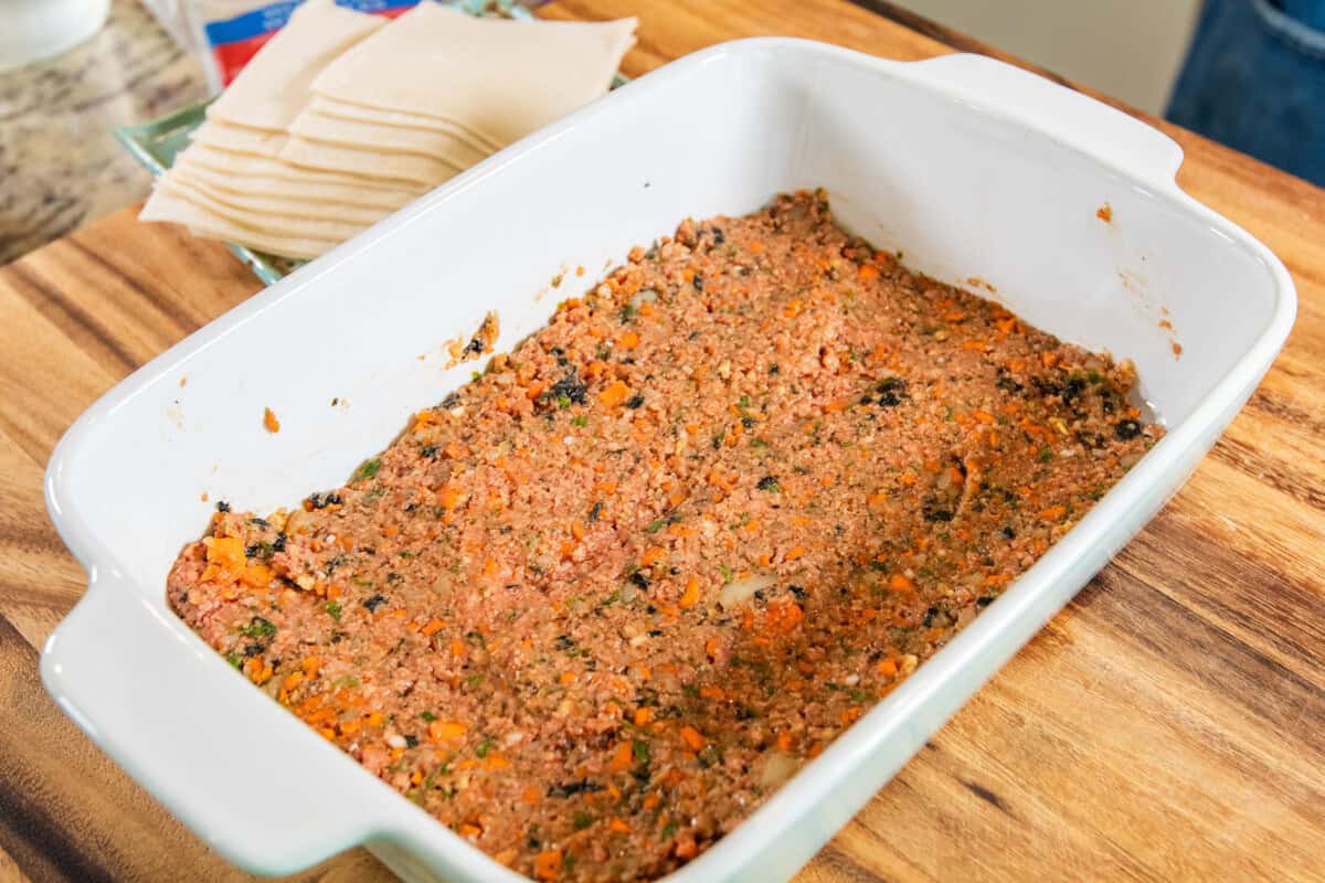 layer of lumpia filling in baking dish