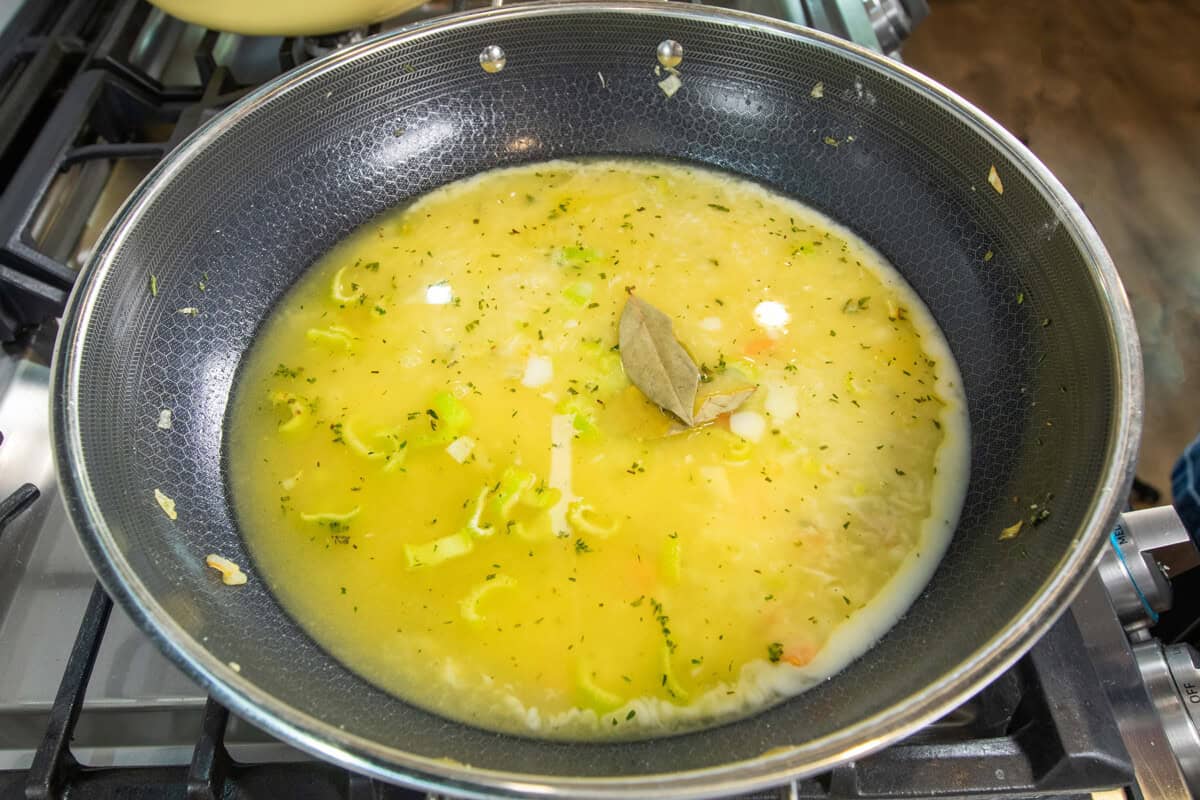 adding a bay leaf to the pot