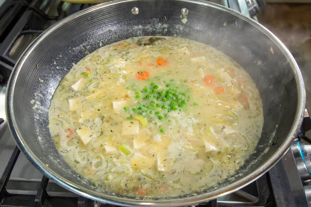 adding peas to large pot