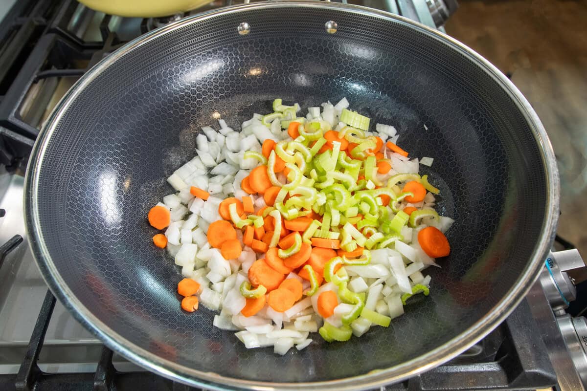 adding carrots and celery to the pot