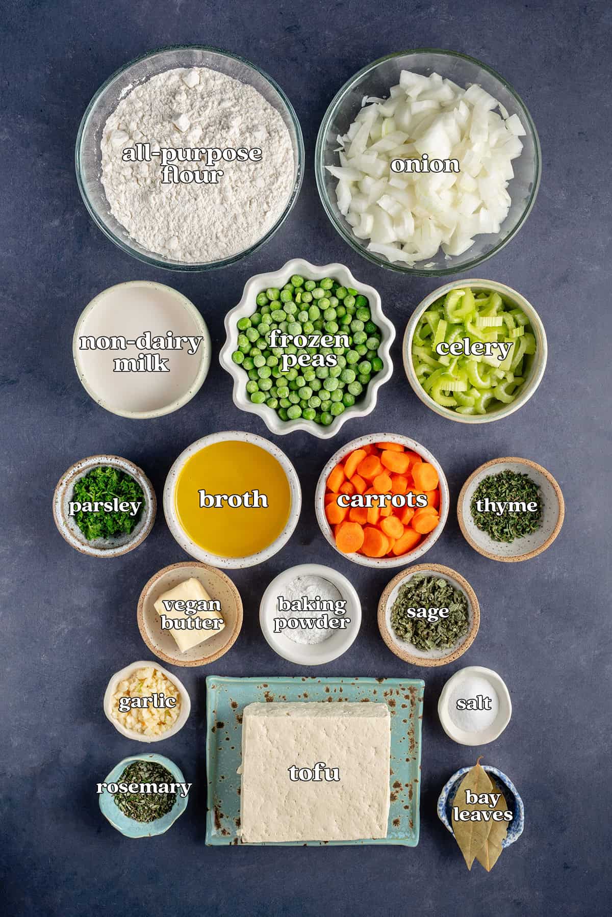 all-purpose flour, onion, non-dairy, frozen peas, celery, parsley, broth, carrots, thyme, vegan butter, baking powder, sage, garlic, salt, tofu, rosemary, bay leaves