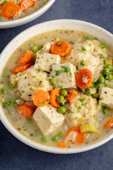 bowl of tofu and dumplings on blue background