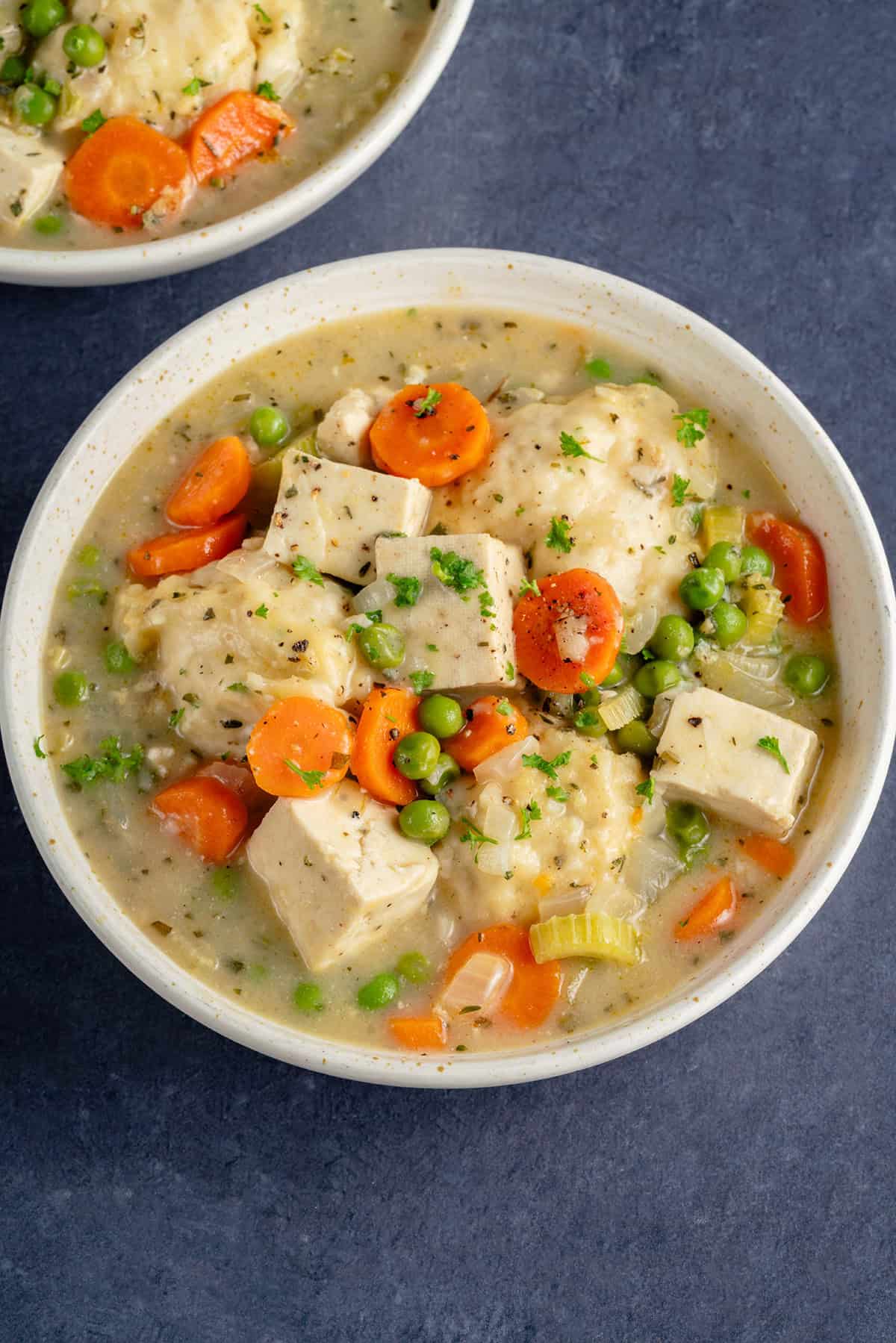 bowl of tofu and dumplings on blue background