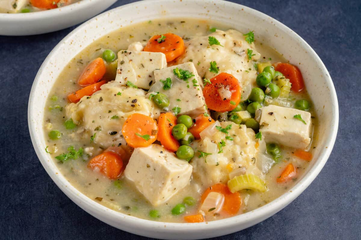 bowl of tofu and dumplings on blue background