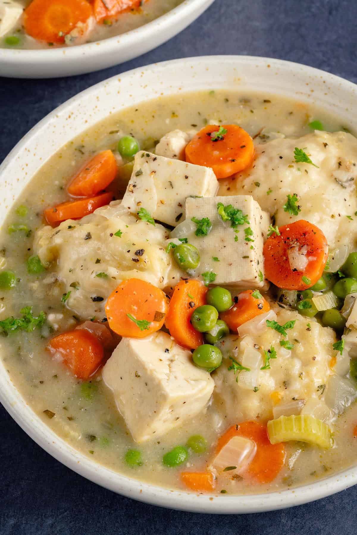 bowl of tofu and dumplings on blue background