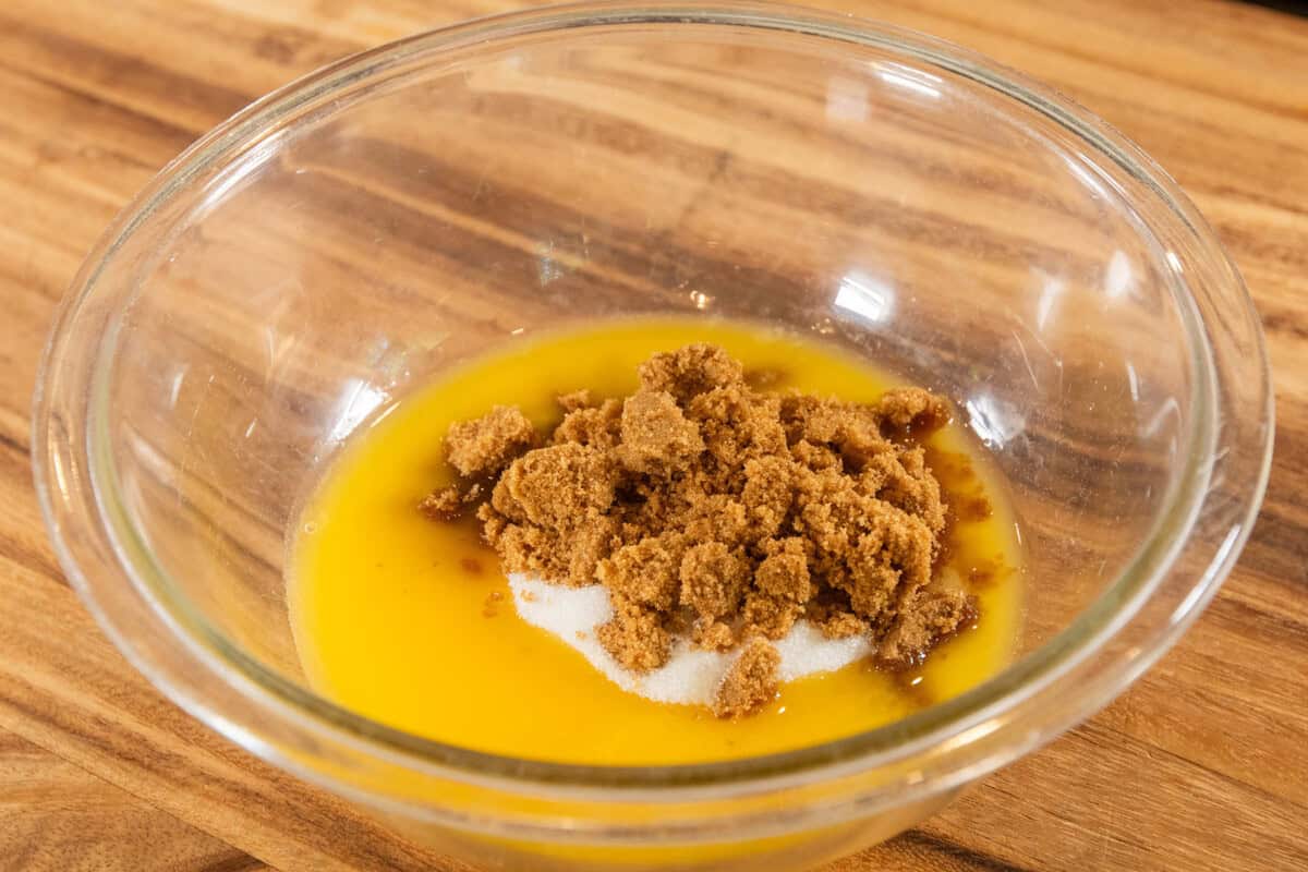 adding sugar and brown sugar to the bowl