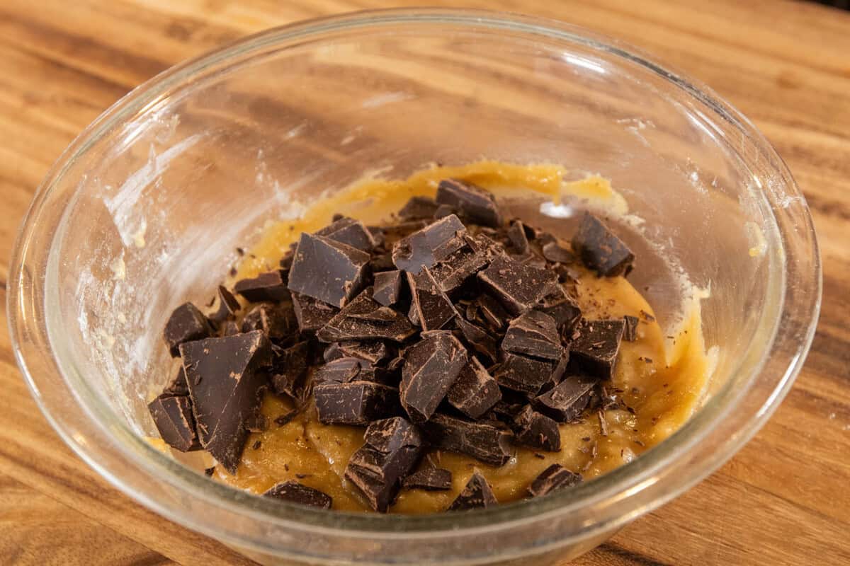 adding chopped chocolate pieces to the dough
