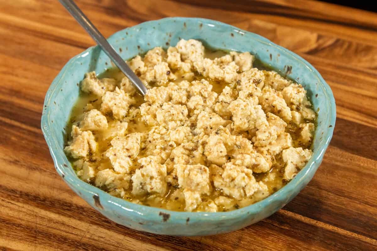 bowl of vegan feta cheese with a spoon sticking out