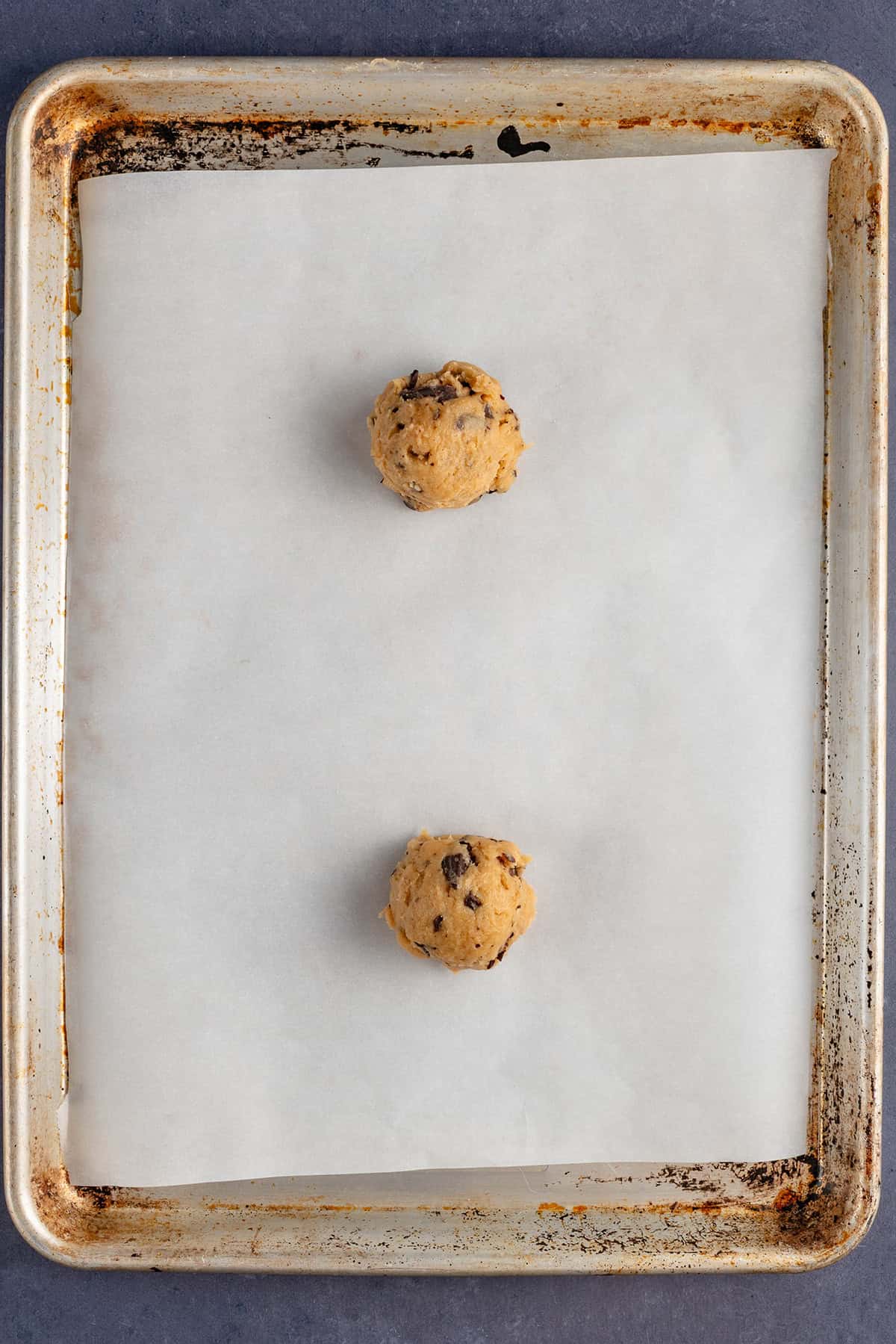 cookie dough balls on lined baking sheet