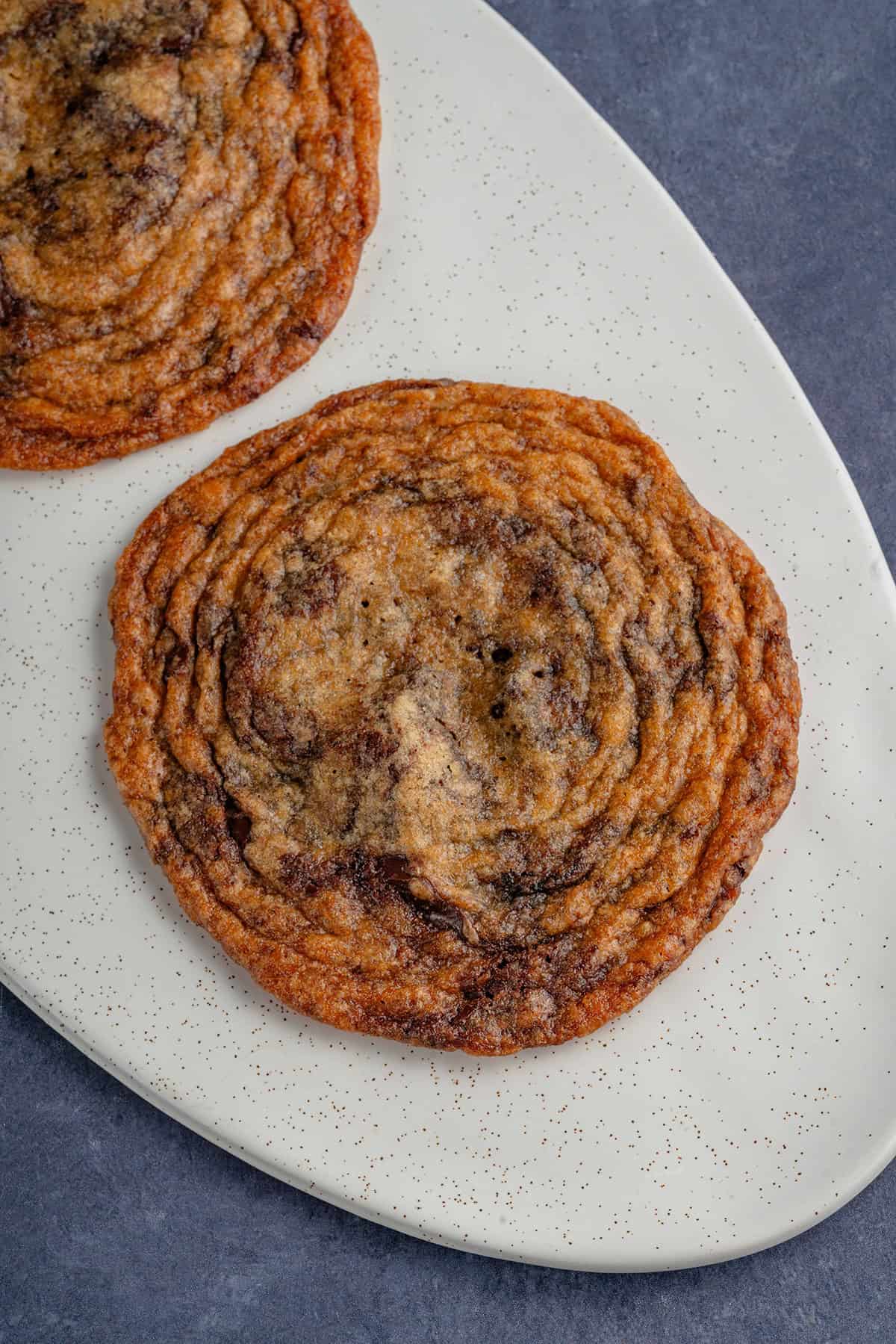 overhead with two thin crispy chocolate chip cookies on platter