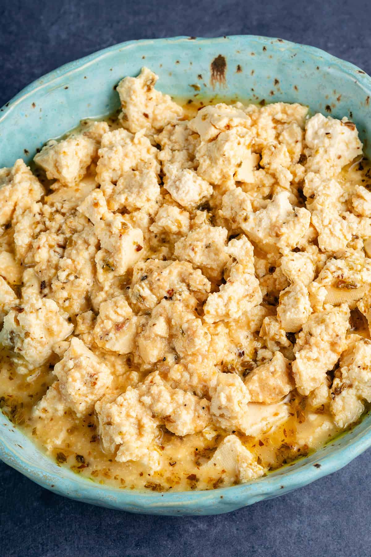 crumbled vegan feta cheese in blue bowl