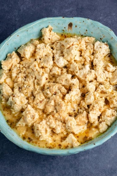 crumbled vegan feta cheese in blue bowl