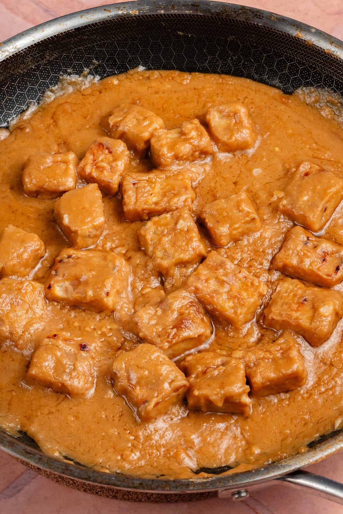 peanut braised tempeh in a pan