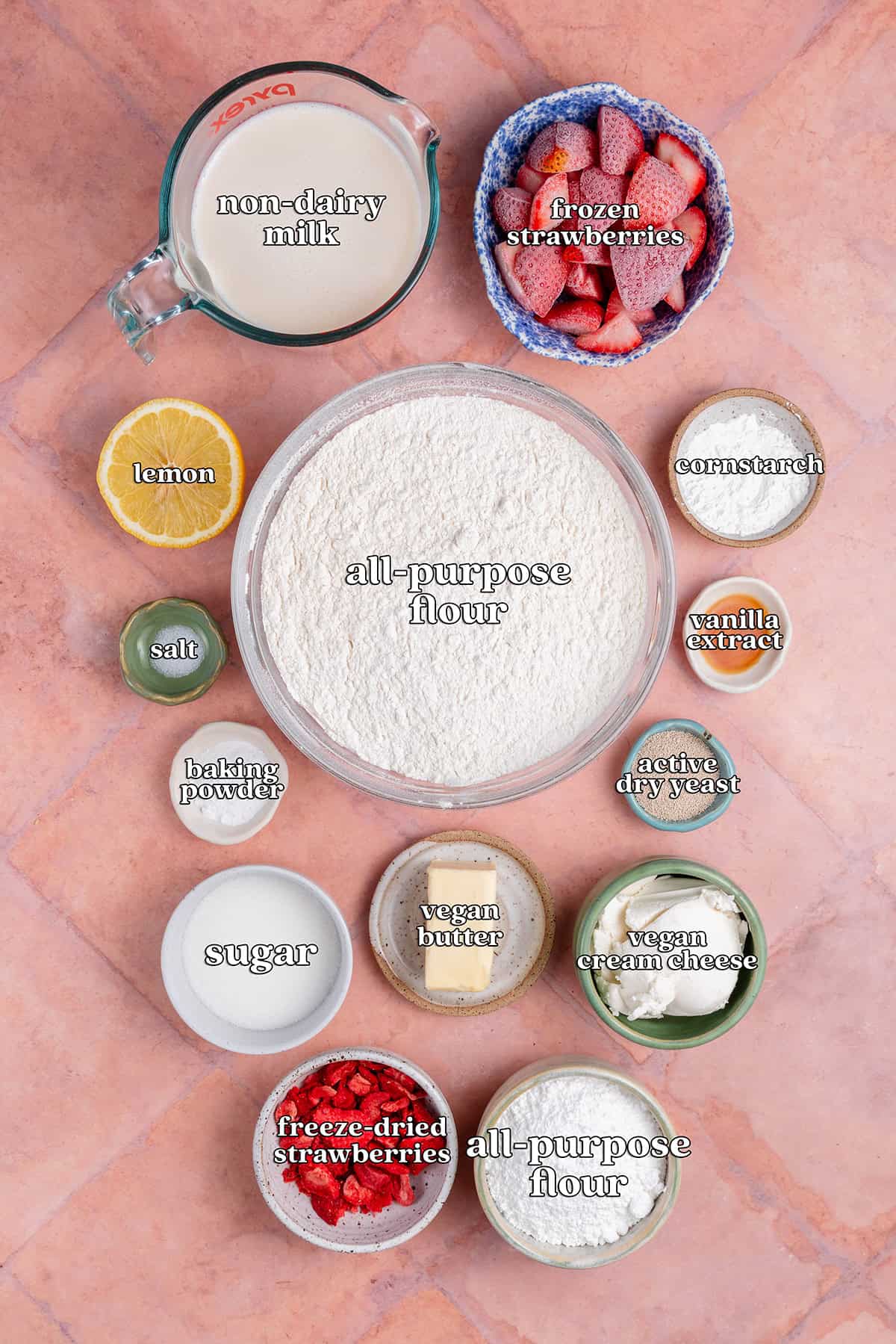non-dairy milk, frozen strawberries, lemon, all-purpose flour, cornstarch, salt, vanilla extract, baking powder, active dry yeast, sugar, vegan butter, vegan cream cheese, freeze-dried strawberries, all-purpose flour