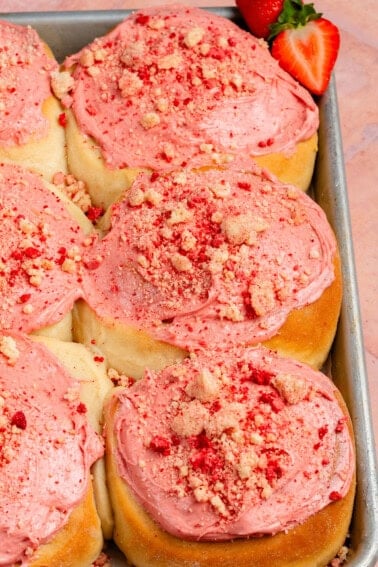 finished strawberry shortcake sweet rolls on sheet pan
