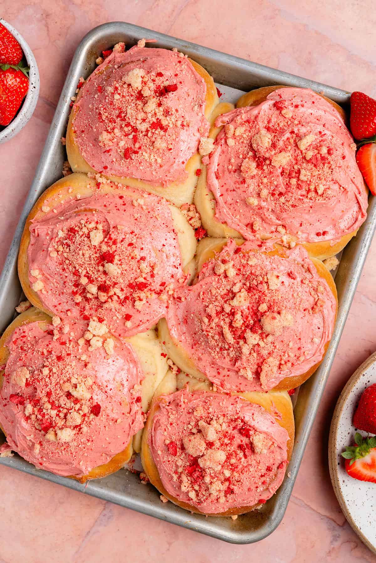 overhead of finished strawberry shortcake sweet rolls on sheet pan