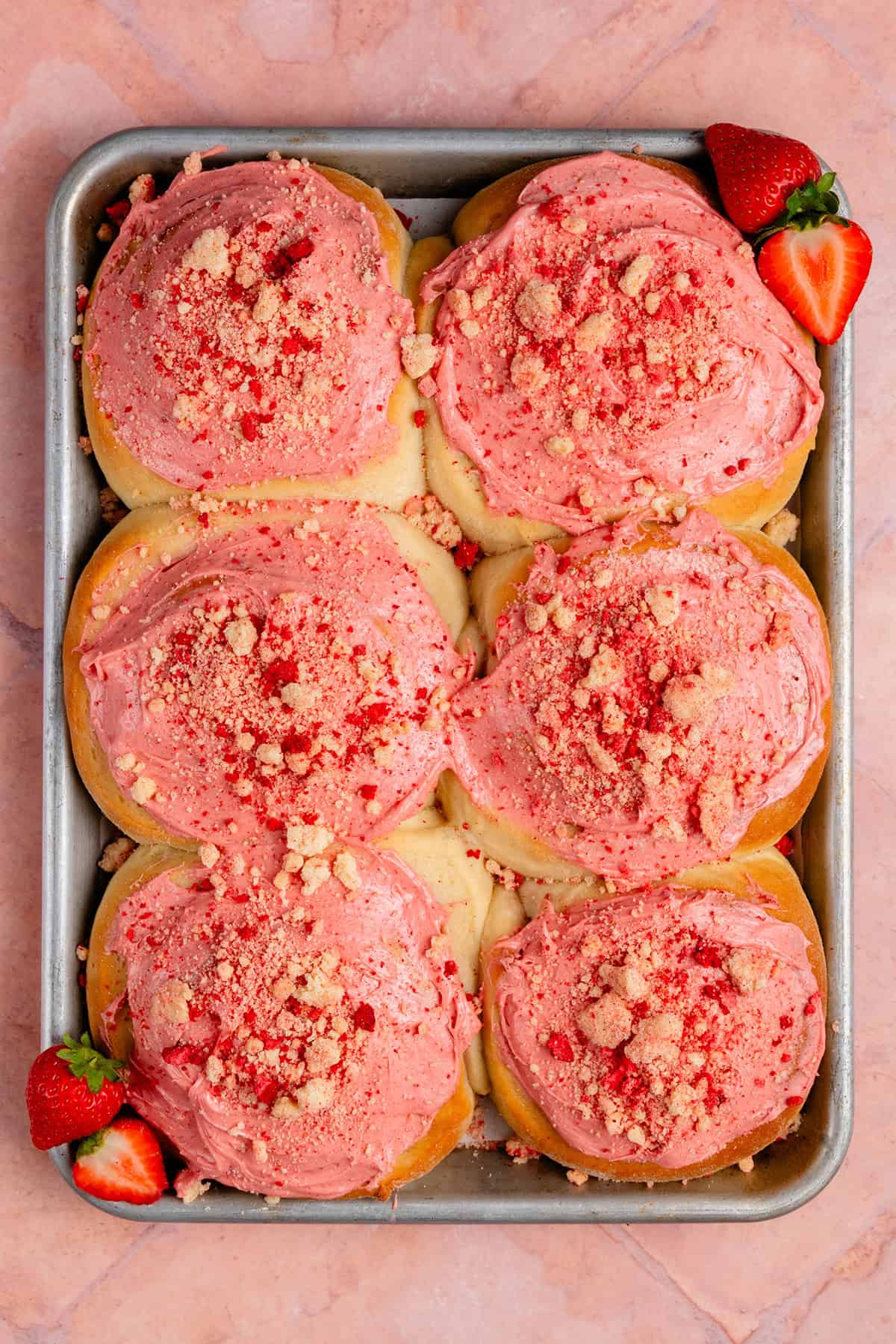 overhead of finished strawberry shortcake sweet rolls on sheet pan