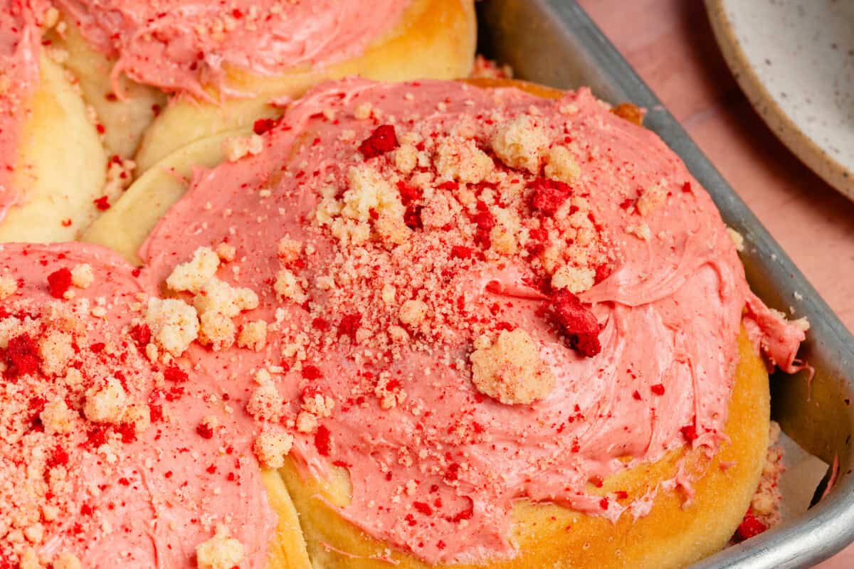 close up of strawberry shortcake sweet rolls in sheet pan