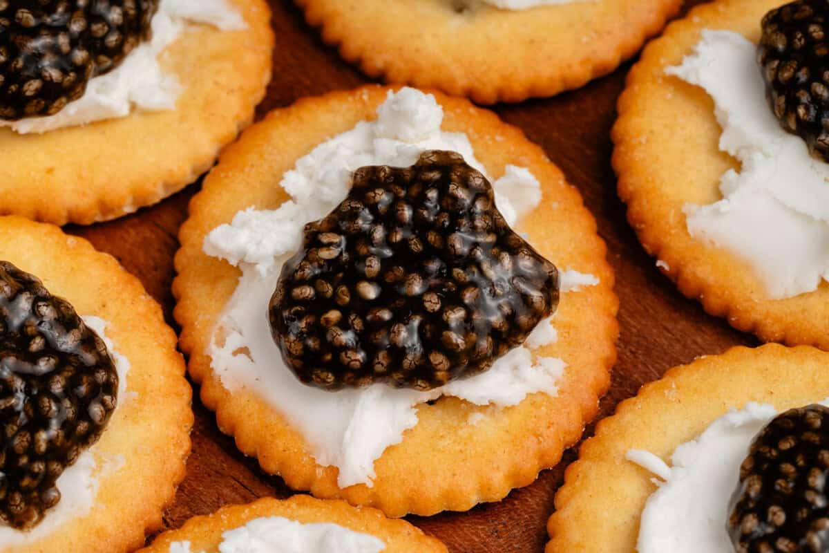 close up of vegan chia seed caviar on crackers with cream cheese