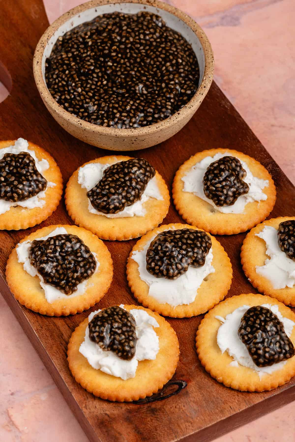 vegan chia seed caviar on crackers with cream cheese