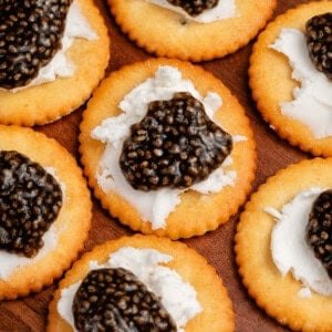 vegan chia seed caviar on crackers with cream cheese
