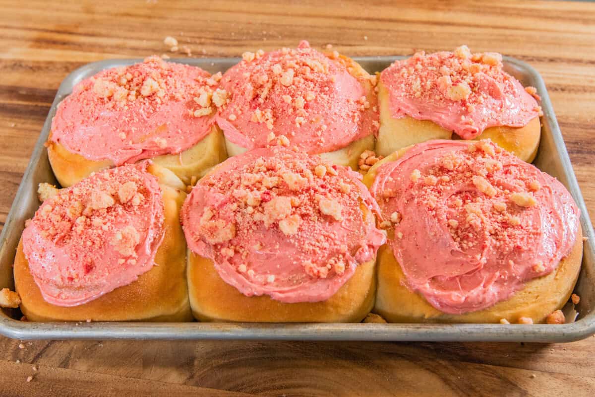 finished strawberry shortcake sweet rolls on a sheet pan