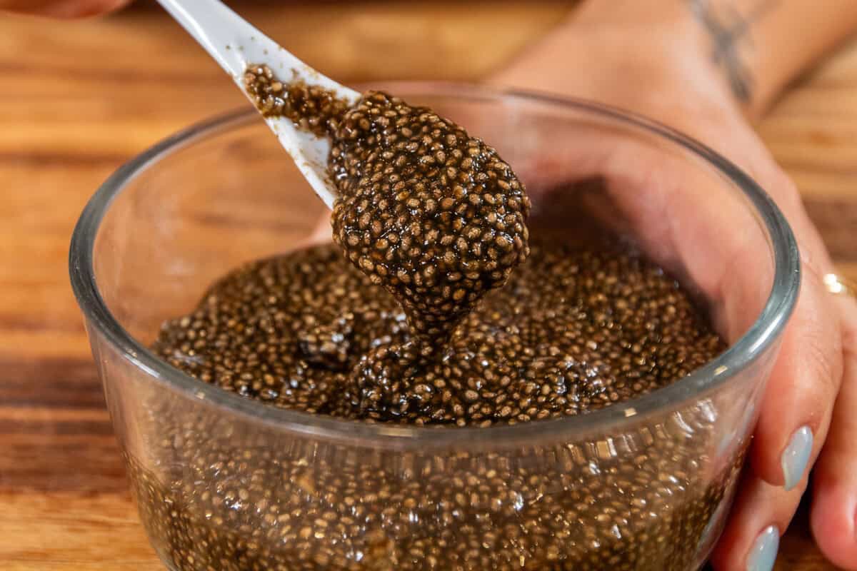 spoonful of chia seed caviar being scooped out of a bowl