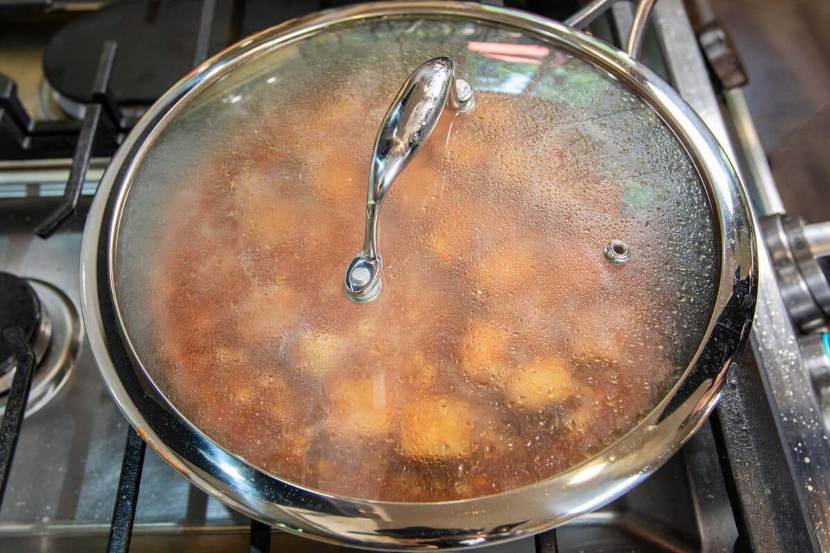 covered skillet with tempeh braising inside