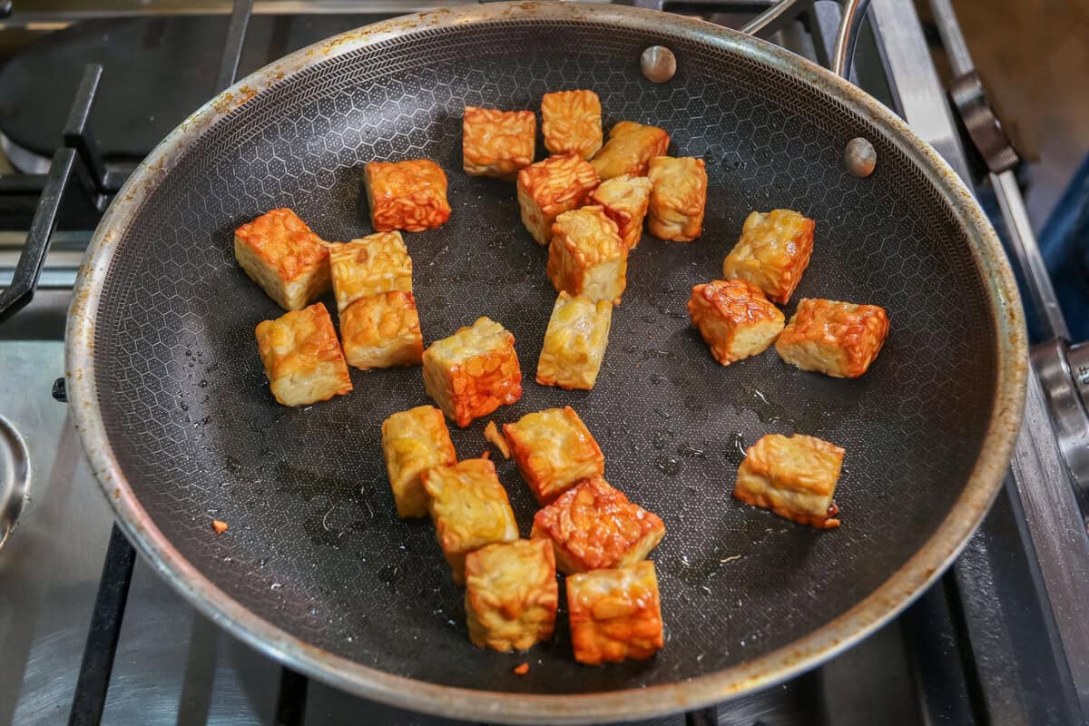 pan frying tempeh in skillet