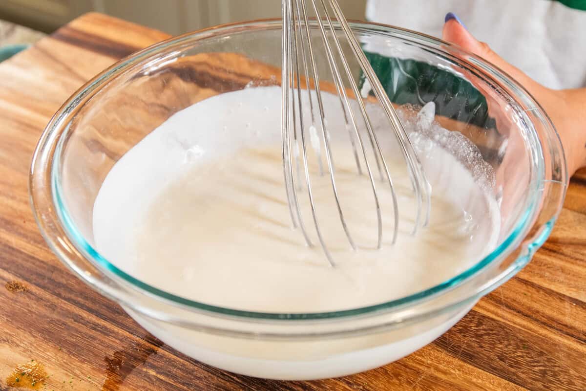 whisking coconut milk and condensed coconut milk in a bowl