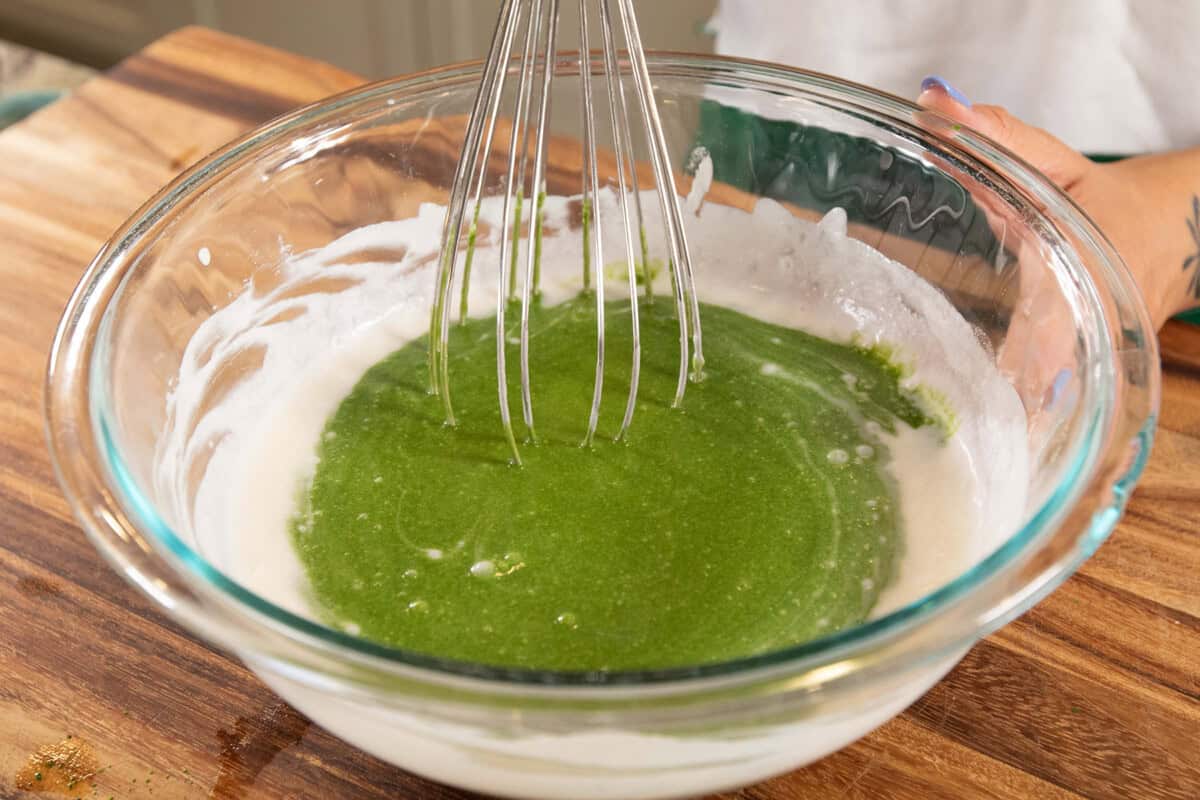 whisking matcha and coconut milk in a bowl