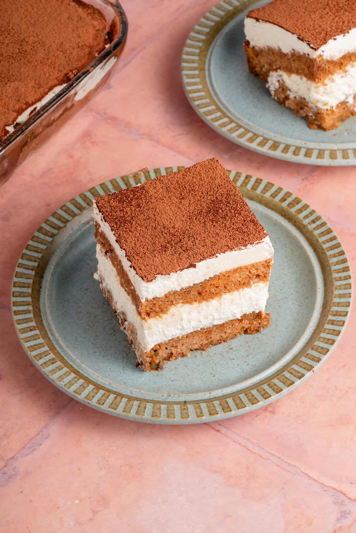a slice of banana bread tiramisu with another in the background