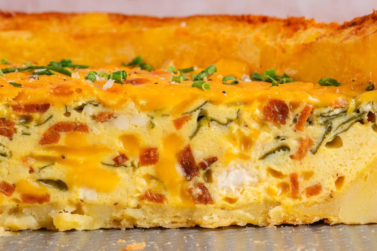close up of the inside of a slice of potato crusted quiche