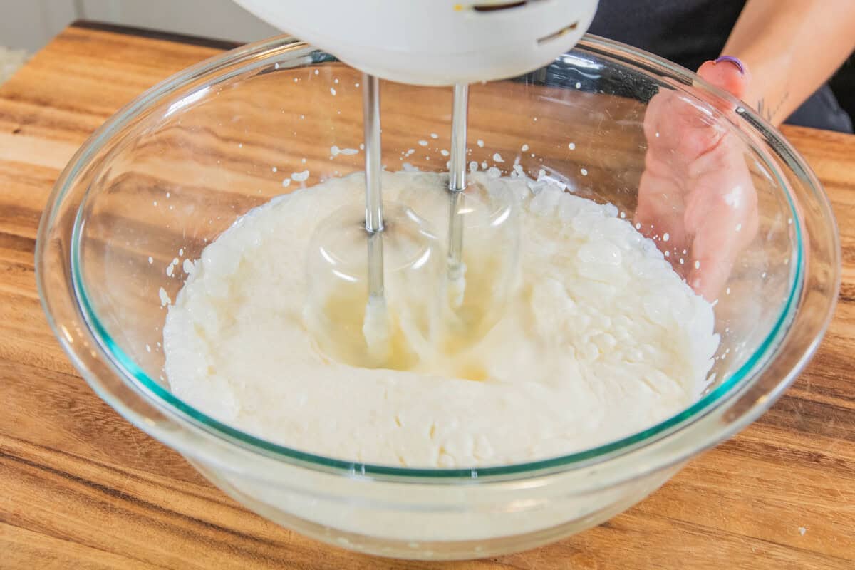 whipping vegan heavy cream in a bowl