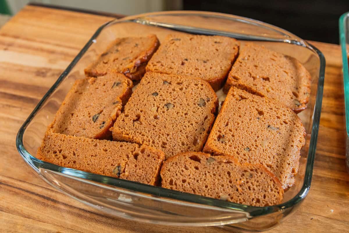 adding another layer of soaked banana bread on top of the cream