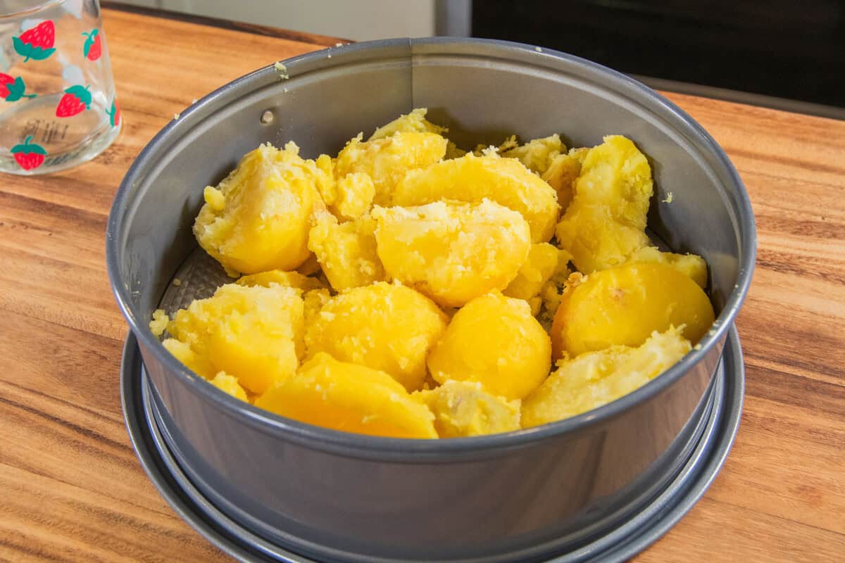 cooked potatoes in springform pan before being mashed