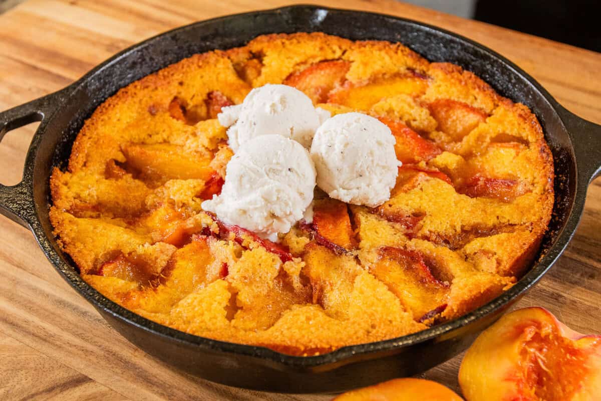finished peach cornbread cobbler with ice cream on top