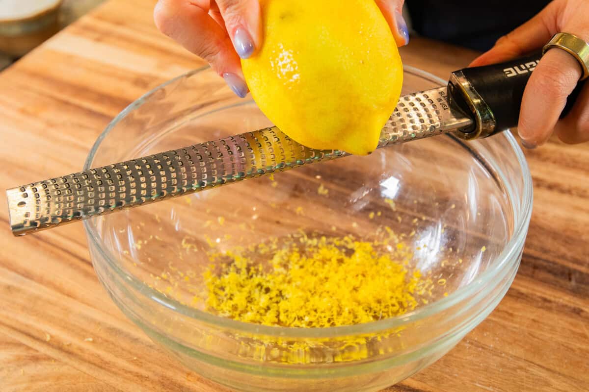 zesting lemon into a bowl