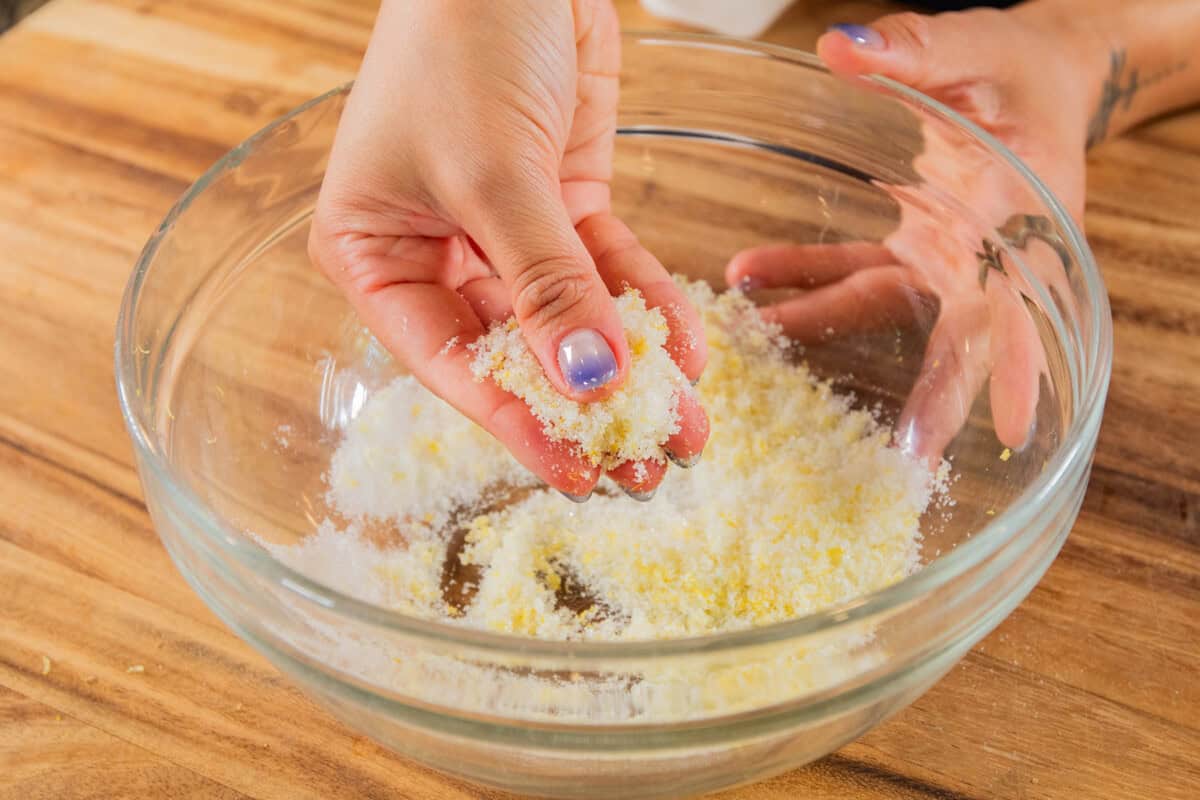 massaging together lemon zest and sugar with fingers
