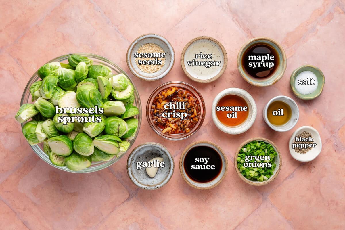 brussels sprouts, sesame seeds, rice vinegar, maple syrup, salt, chili crisp, sesame oil, oil, garlic, soy sauce, green onions, black pepper