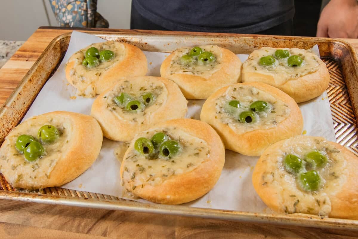 golden Olive Chive Cream Cheese Rolls on baking sheet