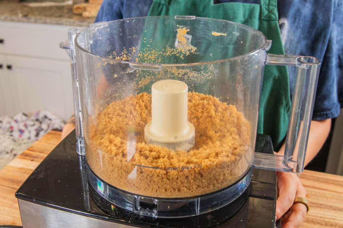 mixing ingredients for graham cracker crust in food processor