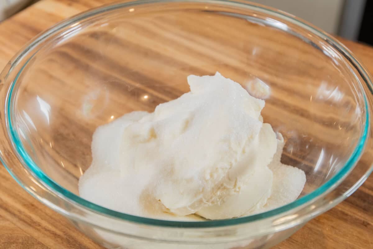 ingredients for a pumpkin cheesecake bar filling in glass bowl before mixing