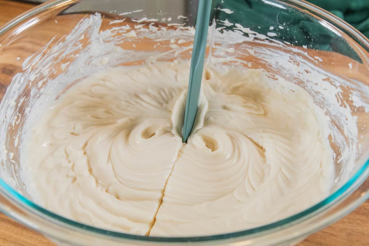 dividing pumpkin cheesecake bar filling in glass bowl