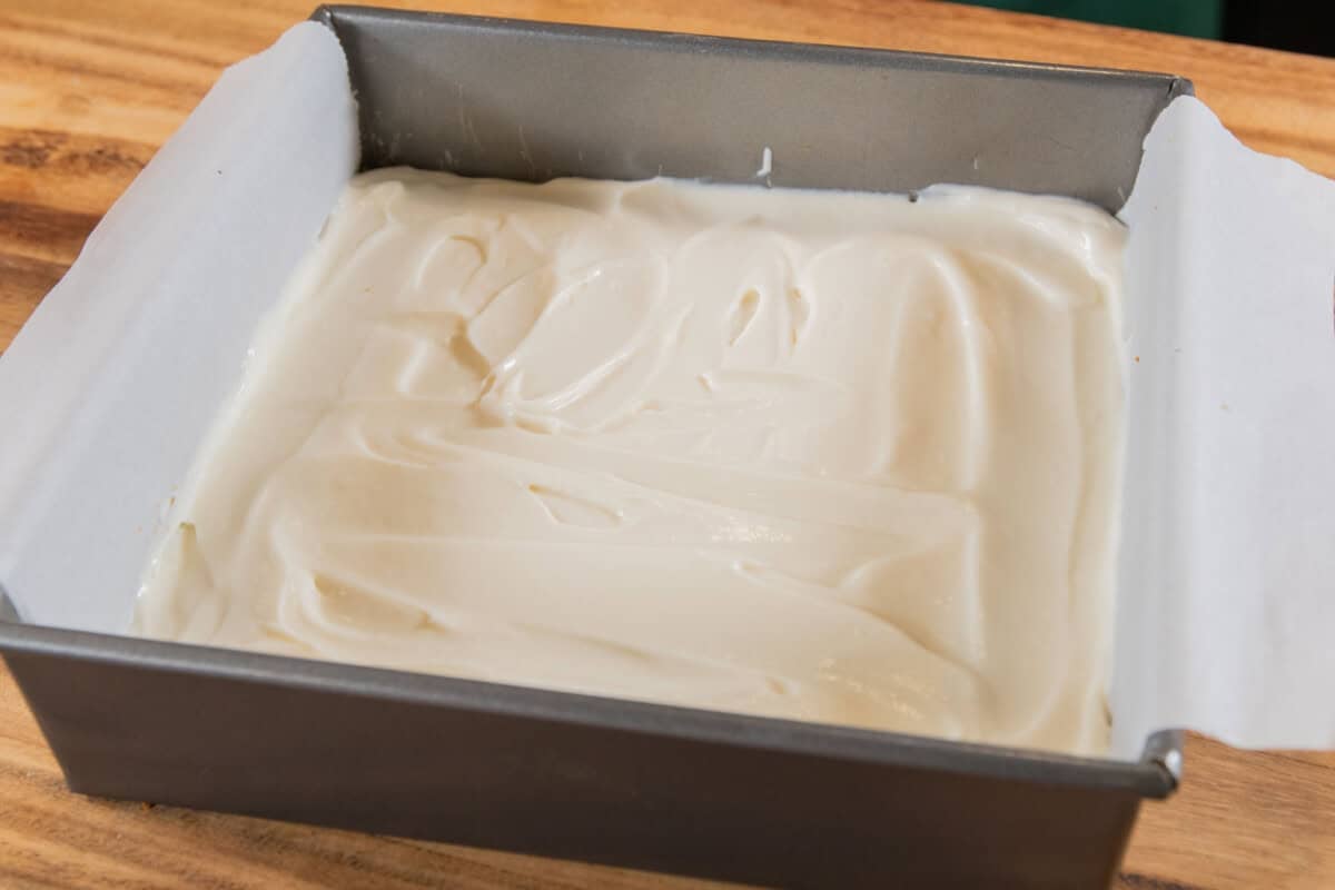 tangy vanilla cheesecake layer for pumpkin cheesecake bar filling in baking dish