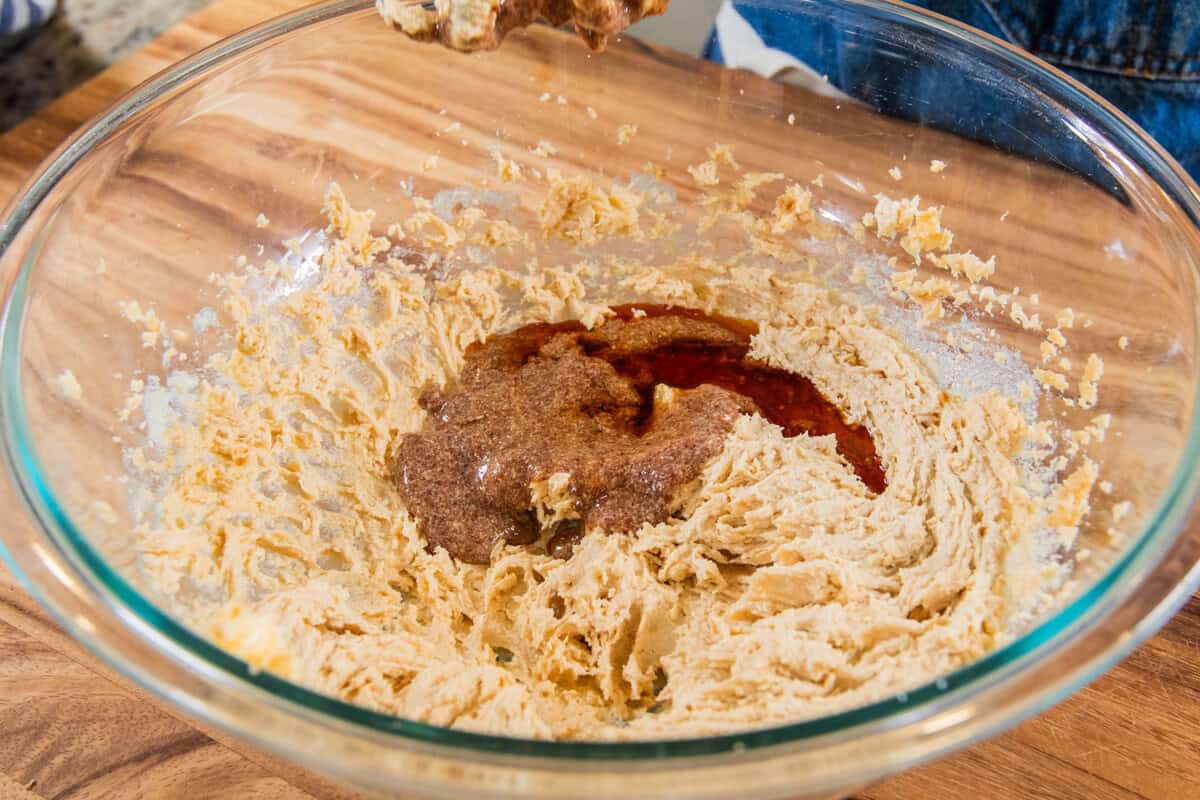 adding flaxseed meal and maple syrup to the whipped butter and sugar