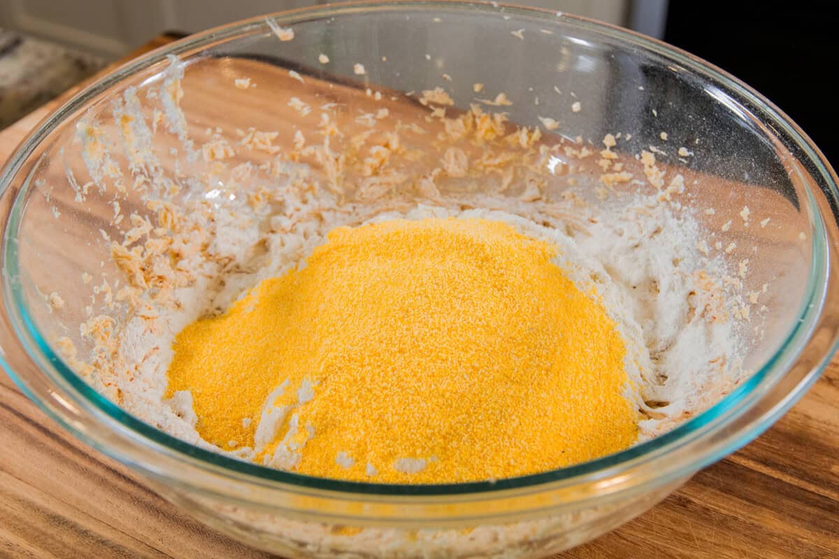 cornmeal added to the bowl of flour, butter and sugar